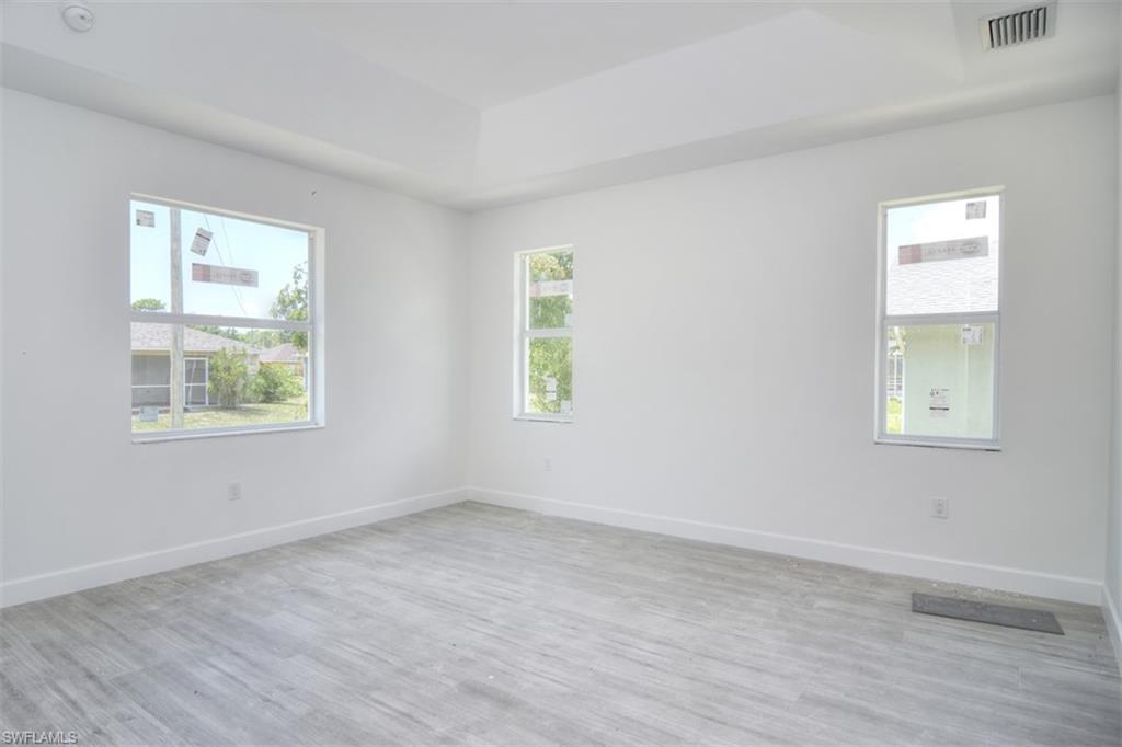 18412 Fuchsia Road Fort Myers, FL 33967 - Photo 16 of 23 wooden floor in an empty room with a window