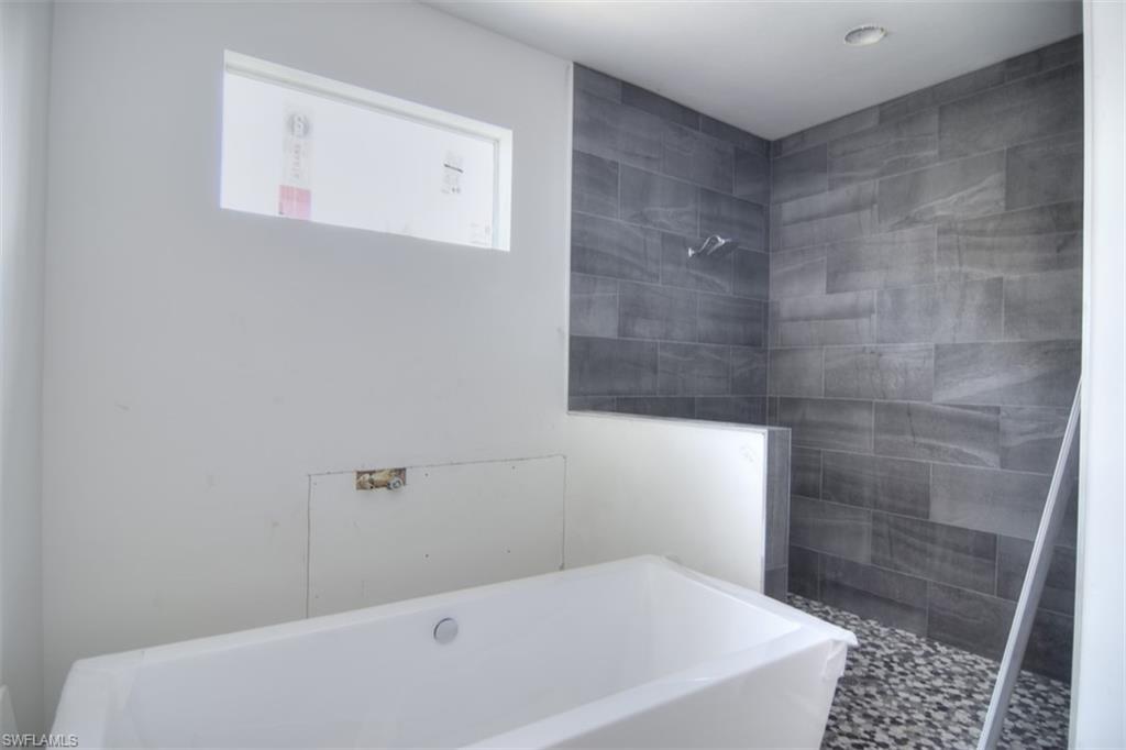 18412 Fuchsia Road Fort Myers, FL 33967 - Photo 17 of 23 a bathroom with a bathtub