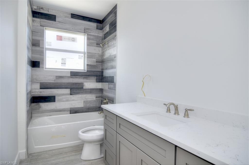 18412 Fuchsia Road Fort Myers, FL 33967 - Photo 20 of 23 a bathroom with a sink a toilet and tub