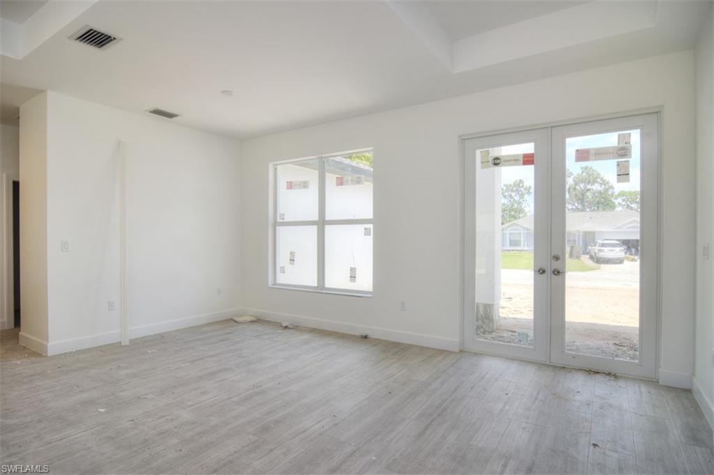 18412 Fuchsia Road Fort Myers, FL 33967 - Photo 6 of 23 a view of an empty room with wooden floor and a window