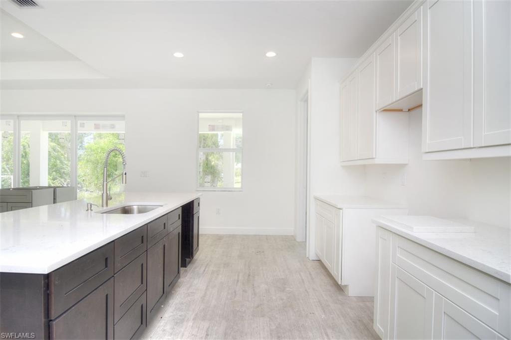 18412 Fuchsia Road Fort Myers, FL 33967 - Photo 8 of 23 a kitchen with a sink and cabinets
