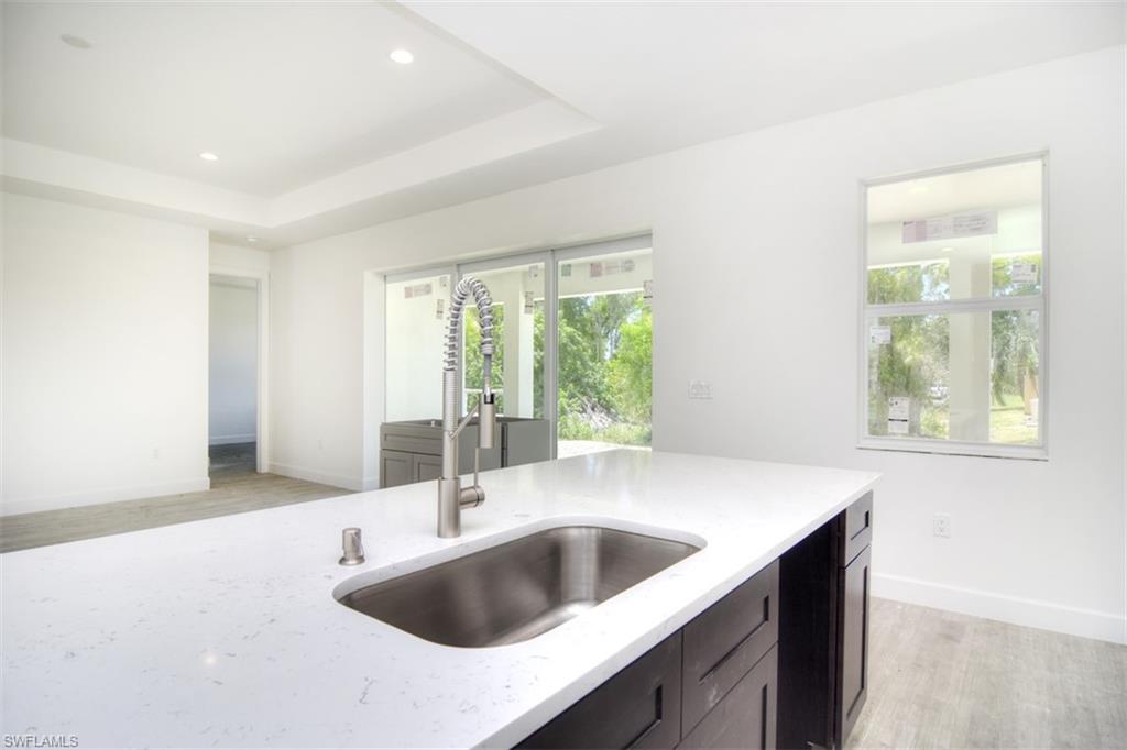 18412 Fuchsia Road Fort Myers, FL 33967 - Photo 10 of 23 a kitchen with a sink and large window