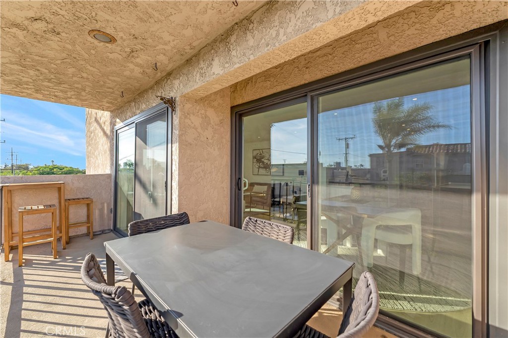 605 Redondo Avenue, Unit 308 Long Beach, CA 90814 - Photo 15 of 38 a view of a dining room with a table and chairs