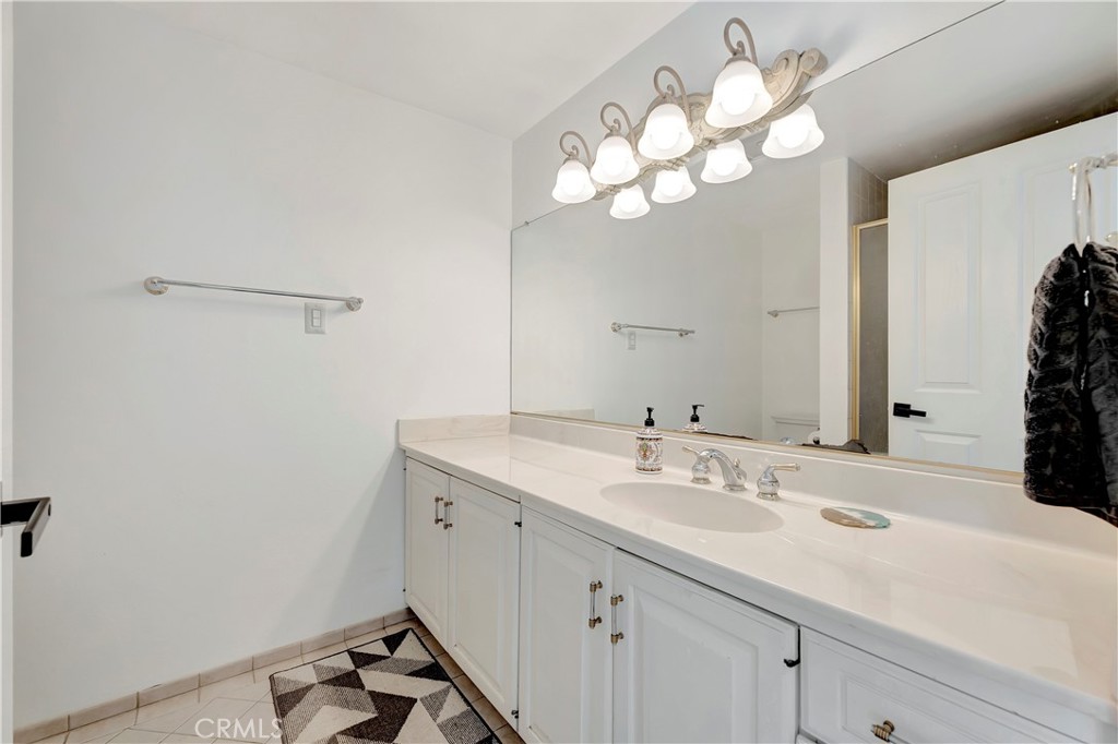 605 Redondo Avenue, Unit 308 Long Beach, CA 90814 - Photo 20 of 38 a bathroom with a sink vanity and a mirror