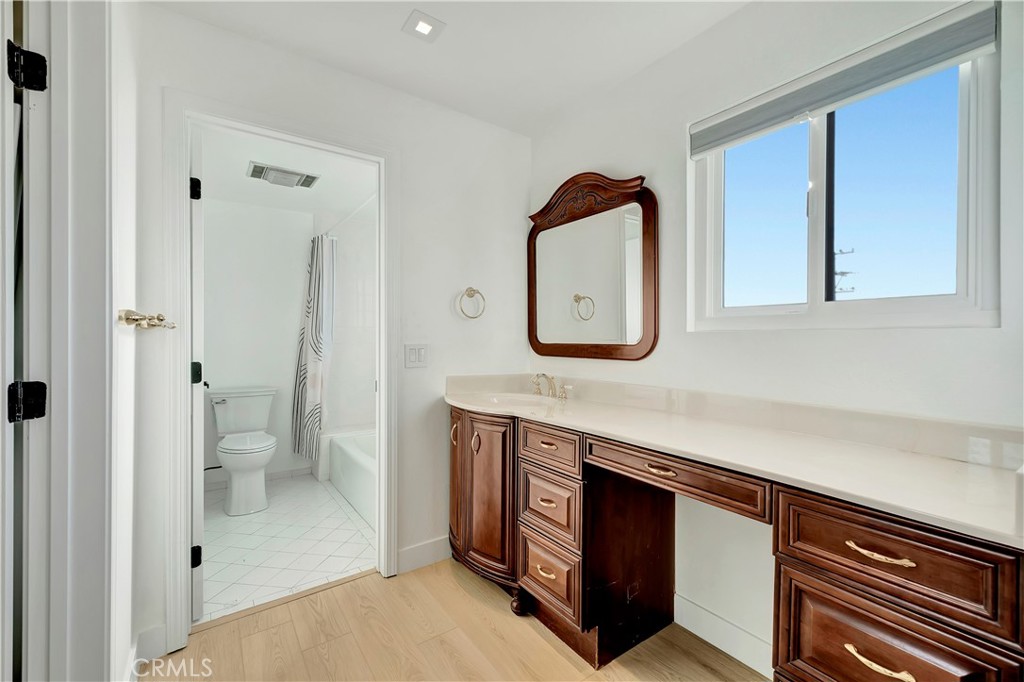 605 Redondo Avenue, Unit 308 Long Beach, CA 90814 - Photo 24 of 38 a bathroom with a sink a toilet and a mirror