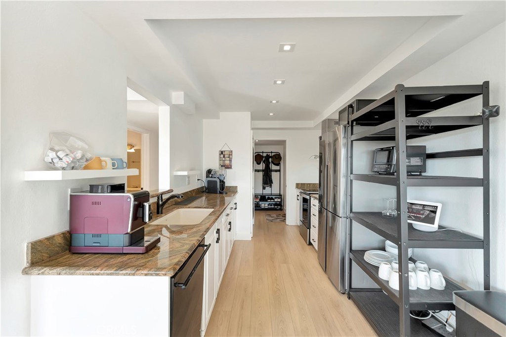 605 Redondo Avenue, Unit 308 Long Beach, CA 90814 - Photo 9 of 38 The kitchen features granite countertops and newer stainless-steel appliances