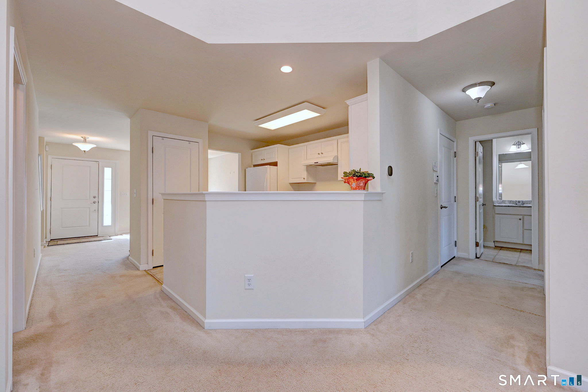 104 Cherry Circle, Unit 104 Prospect, CT 06712 - Photo 15 of 37 wooden floor and white kitchen