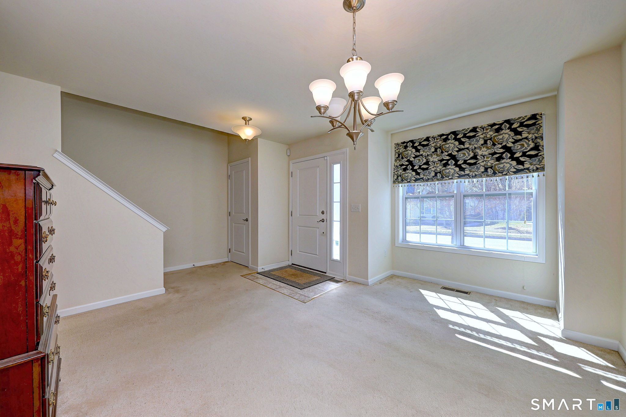 104 Cherry Circle, Unit 104 Prospect, CT 06712 - Photo 8 of 37 a view of a livingroom with a chandelier fan and windows