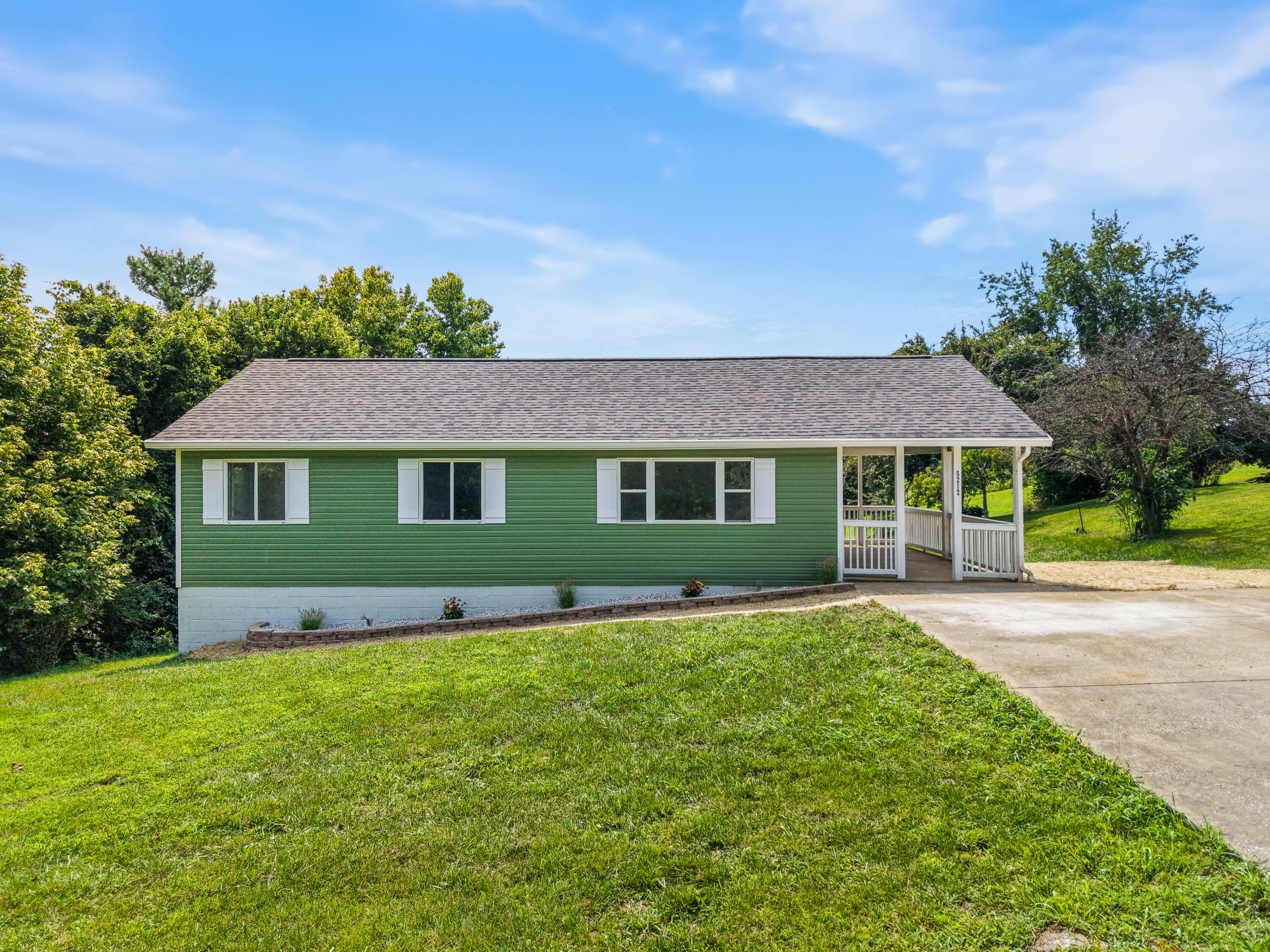5212 Cody Road Independence, KY 41051 - Photo 1 of 38 Ranch on a walkout basement, featuring green siding, a gray shingle roof, and white-framed windows
