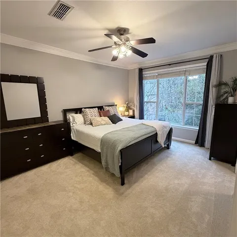 a bedroom with a bed and a large window