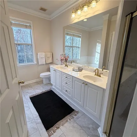 a bathroom with a tub a sink and a large window