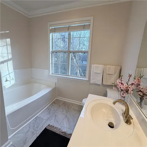 a bathroom with a double vanity sink mirror and toilet