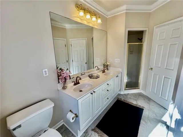 a bathroom with a sink a toilet and a window