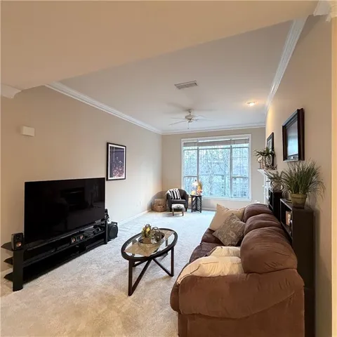 a living room with furniture or couch and a flat screen tv