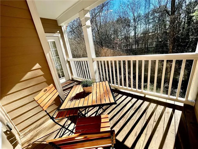 a view of balcony with wooden floor
