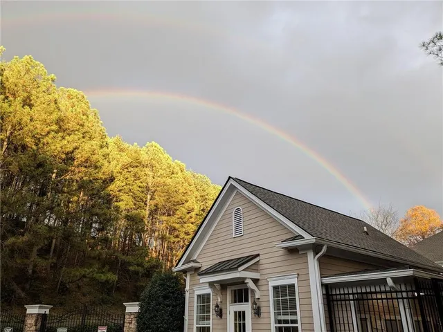 a view of a house with swimming pool and sitting area