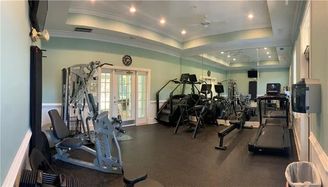 a front view of a house with lots of plants