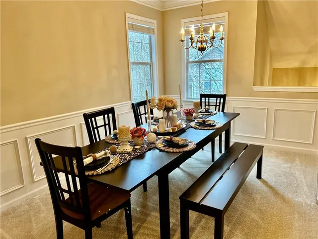 a dining room with furniture and window