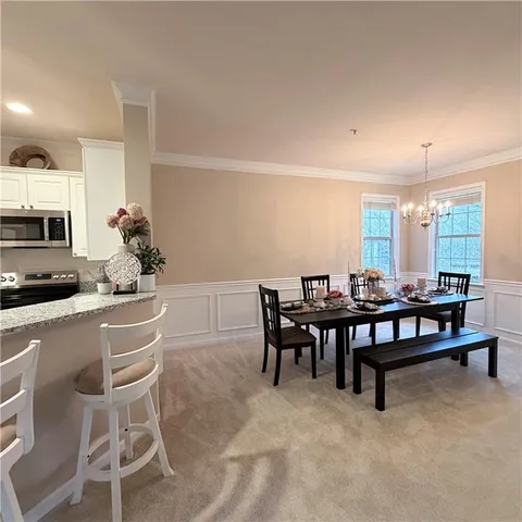 a dining room with furniture and window