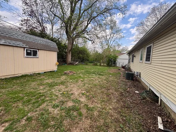 a view of a backyard with large trees