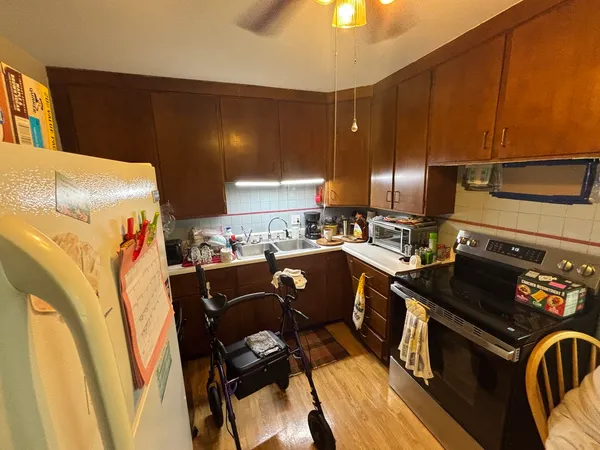 a kitchen with a sink appliances and cabinets