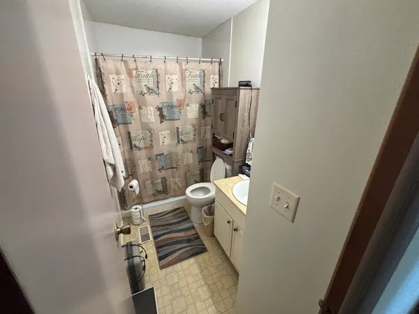 walk in closet with wooden floor washer and dryer