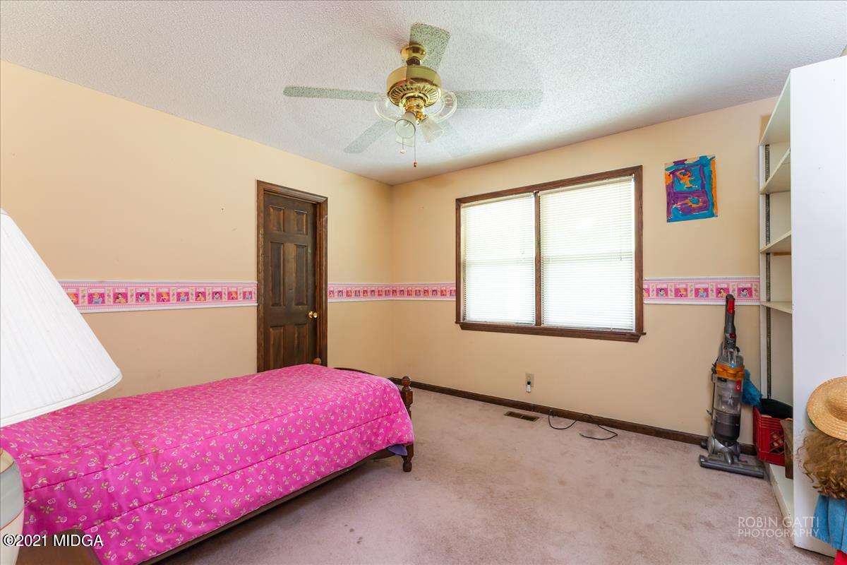 6464 Britt Road Macon, GA 31216 - Photo 8 of 10 a bedroom with a bed and a window