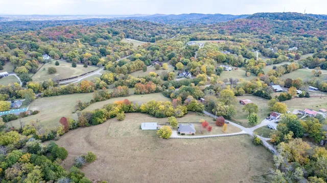 an aerial view of a houses with a yard