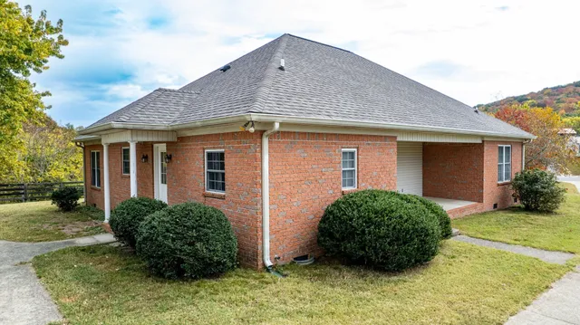 a view of a house with a yard and sitting area
