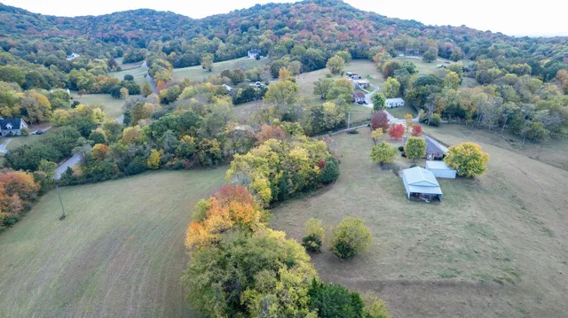 a aerial view of a house with a yard and a garden