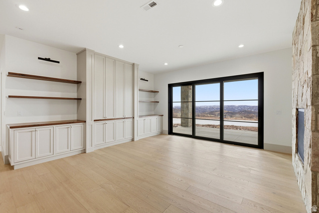 2155 East Wrangler Road Kamas, UT 84036 - Photo 18 of 62 Unfurnished living room featuring light wood-type flooring, a stone fireplace, and recessed lighting