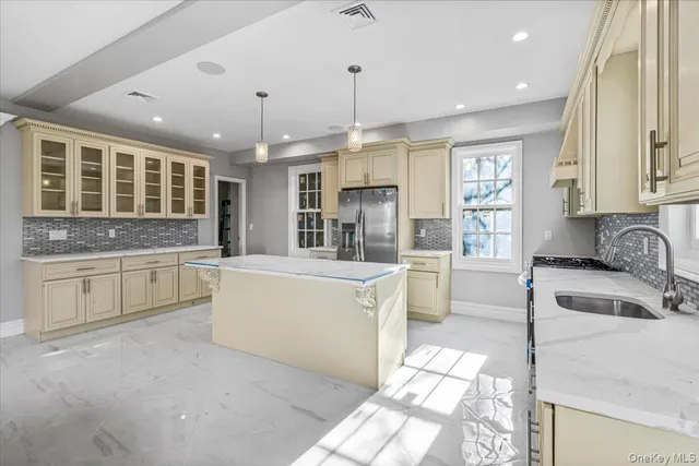 a kitchen with granite countertop a sink stove and cabinets