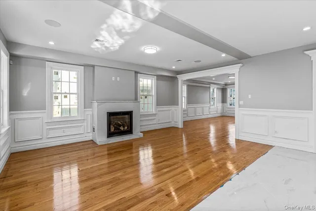 a view of a livingroom with wooden floor and a fireplace