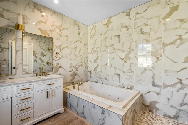 a bathroom with a bathtub and shower