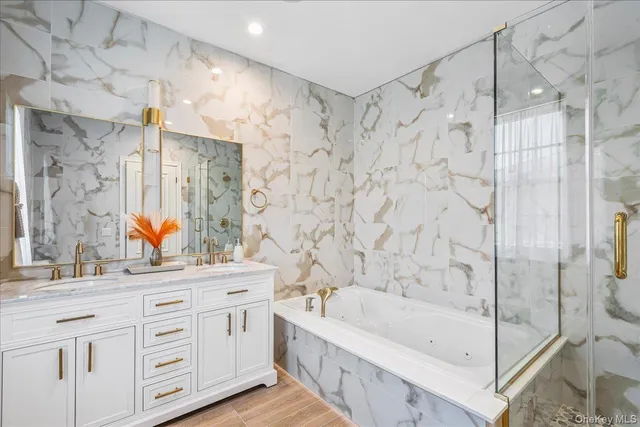 a bathroom with a double vanity sink mirror double and shower