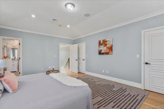 a bedroom with a bed and a painting on the wall