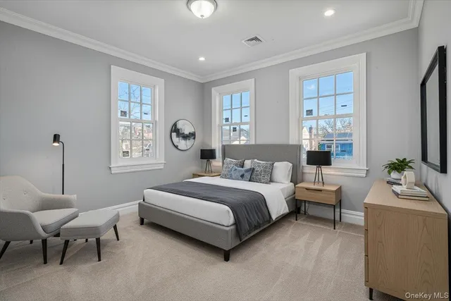 a spacious bedroom with a bed and a couch