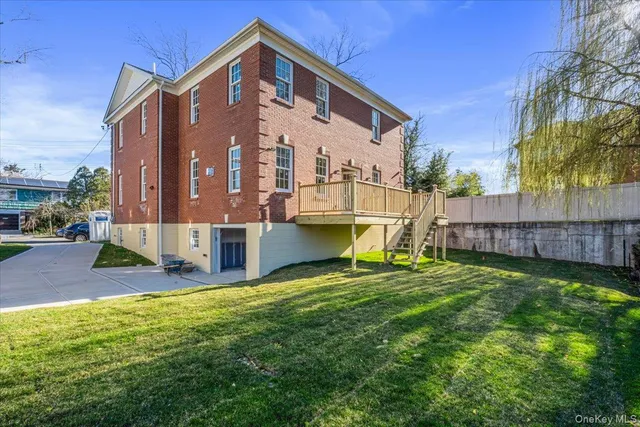 a view of a house with a yard and sitting area