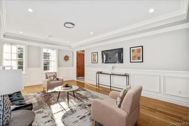 a living room with furniture a rug and a window