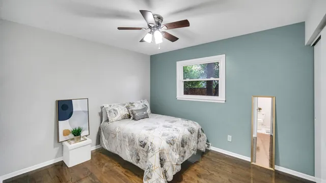 a bedroom with a large bed and a window