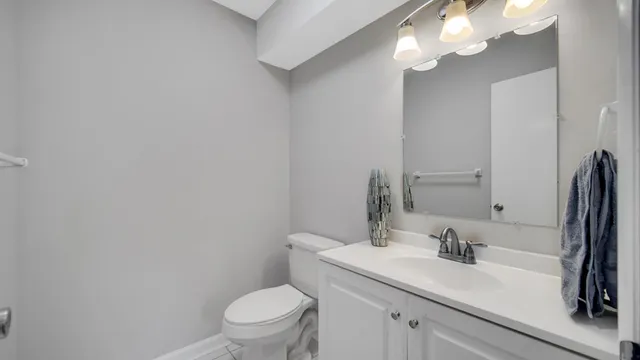 a bathroom with a sink a toilet and a mirror