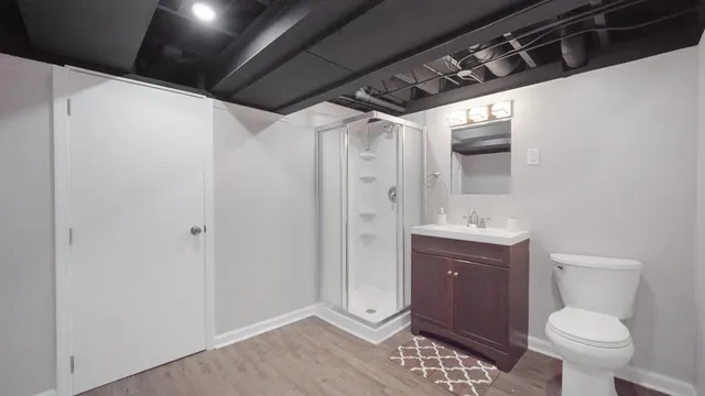 a bathroom with a sink toilet and shower