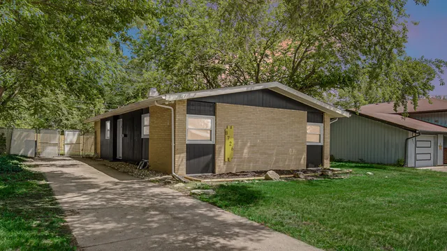 a front view of house with yard and trees