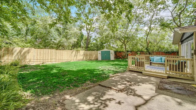 a backyard of a house with table and chairs