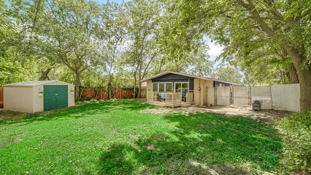 a front view of a house with yard and green space
