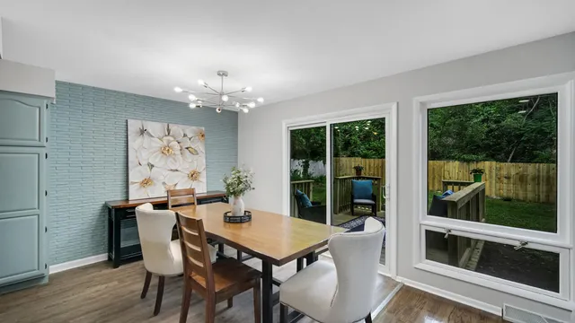 a view of a dining room with furniture large windows and wooden floor