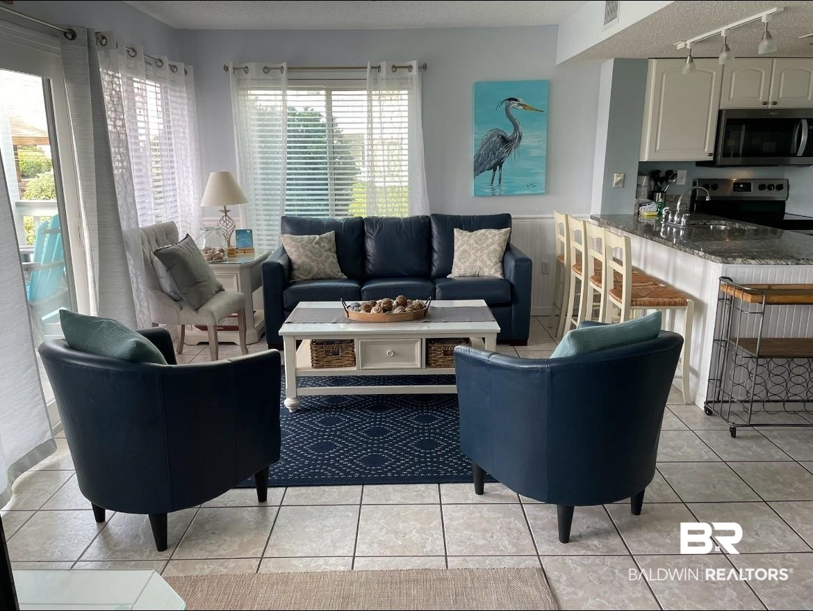 497 Plantation Road, Unit 1156 Gulf Shores, AL 36542 - Photo 8 of 28 Living room with visible vents, rail lighting, and light tile patterned floors