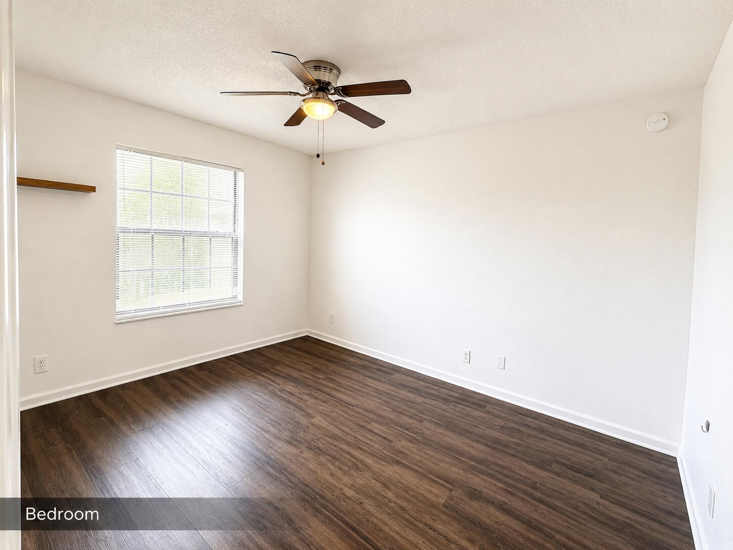 2650 Greenwood Terrace, Unit 2230 Boca Raton, FL 33431 - Photo 13 of 21 an empty room with wooden floor chandelier fan and windows
