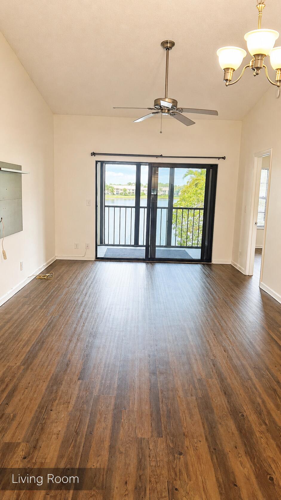 2650 Greenwood Terrace, Unit 2230 Boca Raton, FL 33431 - Photo 2 of 21 an empty room with wooden floor and windows