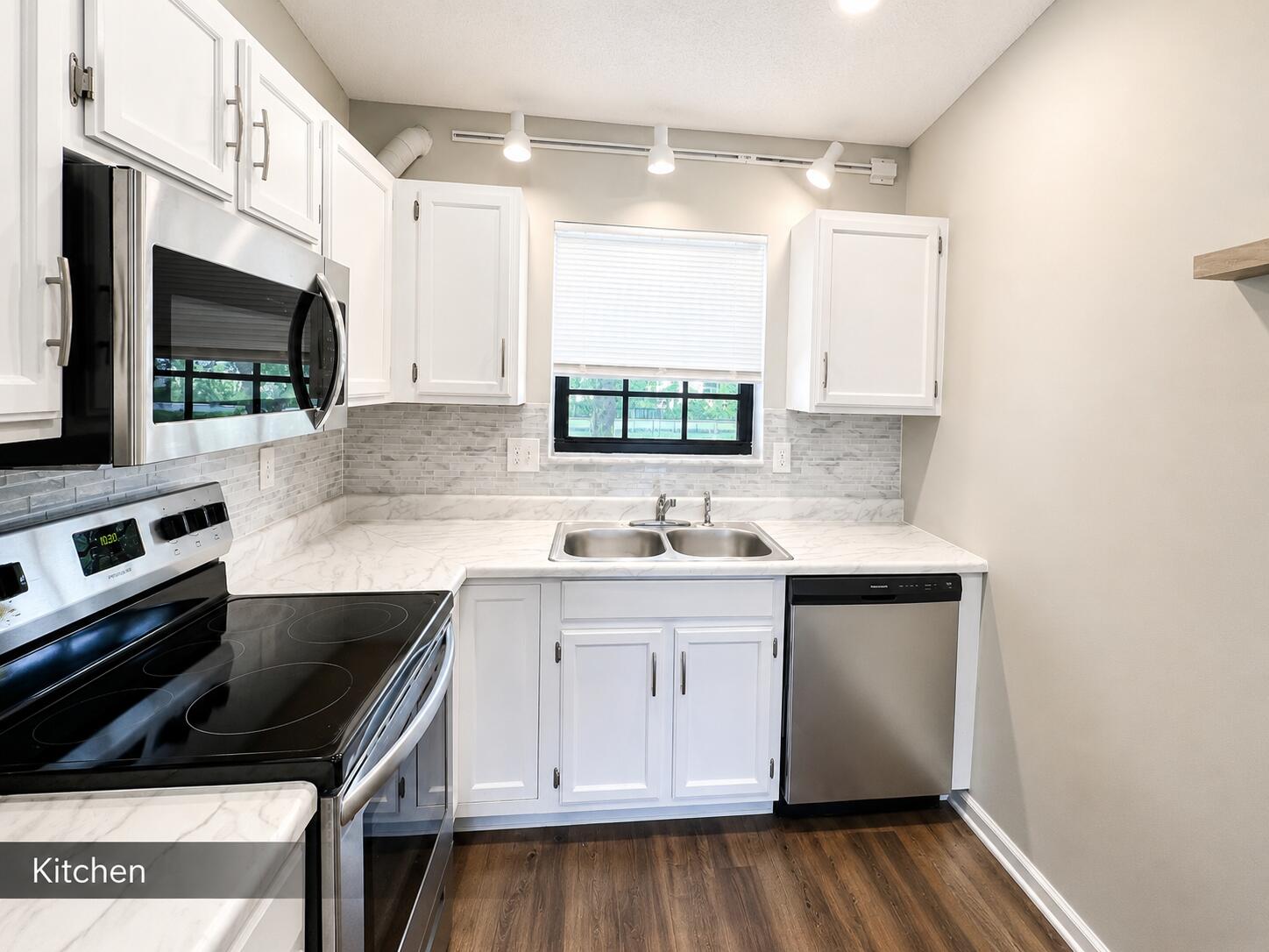 2650 Greenwood Terrace, Unit 2230 Boca Raton, FL 33431 - Photo 5 of 21 a kitchen with a sink stove and microwave